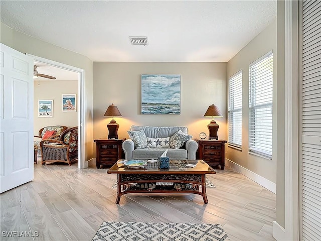 sitting room featuring light hardwood / wood-style flooring and ceiling fan