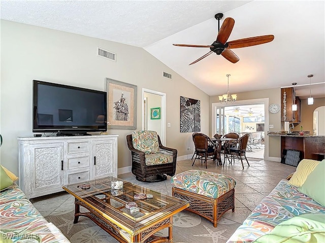 tiled living room with vaulted ceiling and ceiling fan with notable chandelier