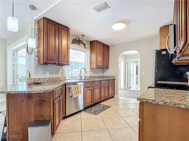 kitchen featuring kitchen peninsula, stainless steel dishwasher, sink, pendant lighting, and light tile patterned floors