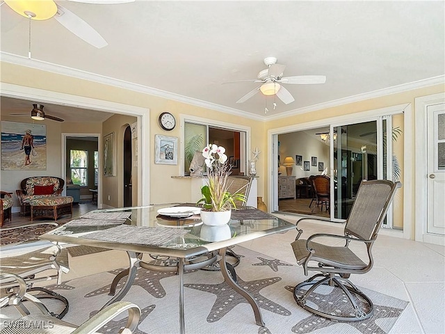 interior space with ceiling fan and crown molding