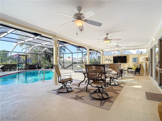 view of swimming pool with glass enclosure and a patio area