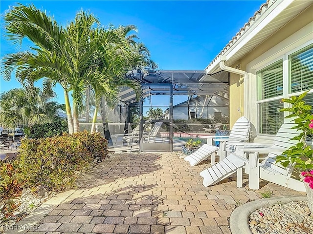 view of patio / terrace featuring a lanai and a swimming pool