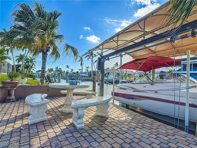 view of patio / terrace with a water view and a dock