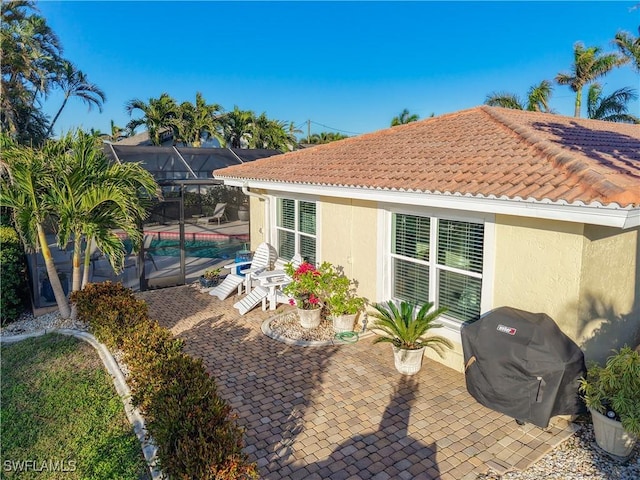 back of property with a lanai and a patio