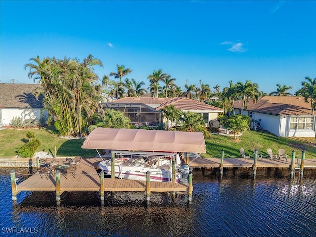 view of dock with a water view, a lanai, and a lawn