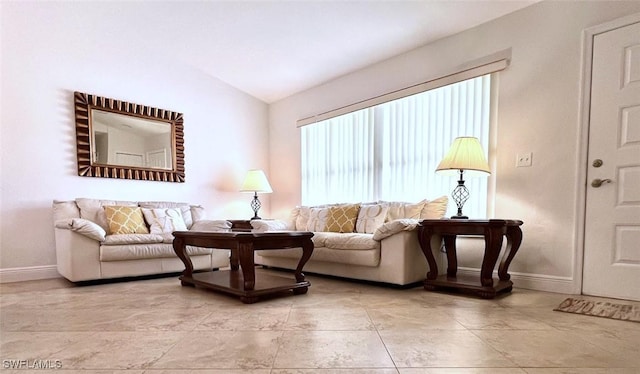 living room featuring lofted ceiling