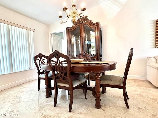 dining area featuring vaulted ceiling and an inviting chandelier