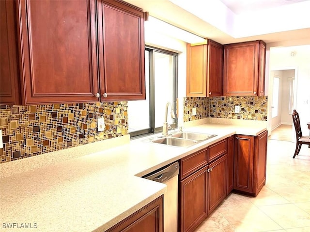 kitchen with stainless steel dishwasher, light tile patterned floors, sink, and tasteful backsplash