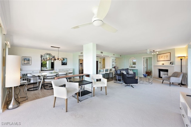 living room with ceiling fan with notable chandelier