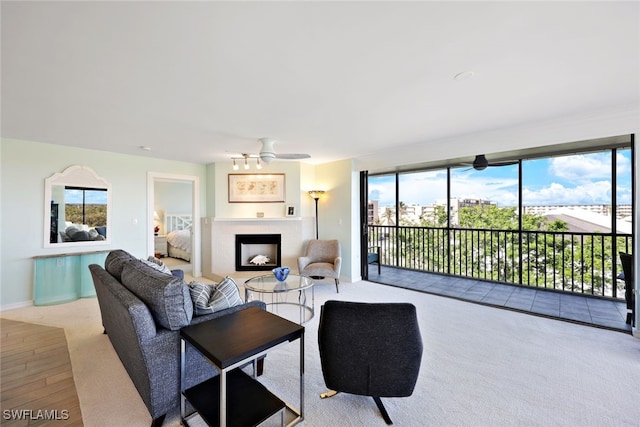 living room with ceiling fan and light carpet