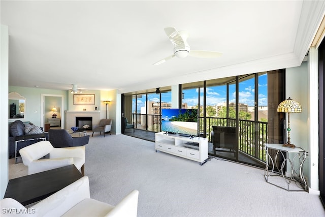 carpeted living room featuring ceiling fan and floor to ceiling windows