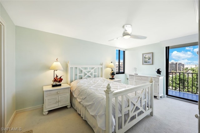 carpeted bedroom featuring access to exterior, multiple windows, and ceiling fan