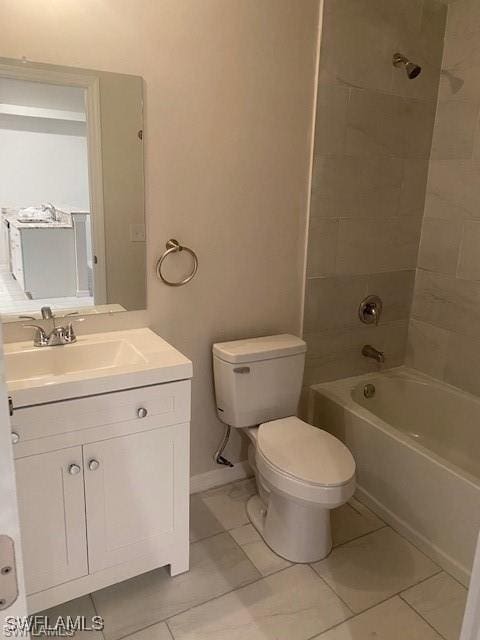 full bathroom with tile patterned flooring, vanity, tiled shower / bath combo, and toilet