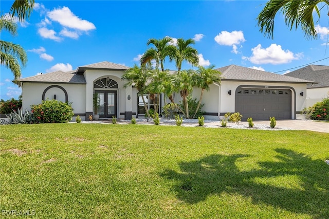 mediterranean / spanish home featuring a front lawn, a garage, and french doors