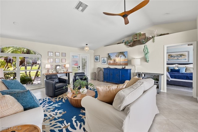 living room featuring light tile patterned floors, vaulted ceiling, and ceiling fan