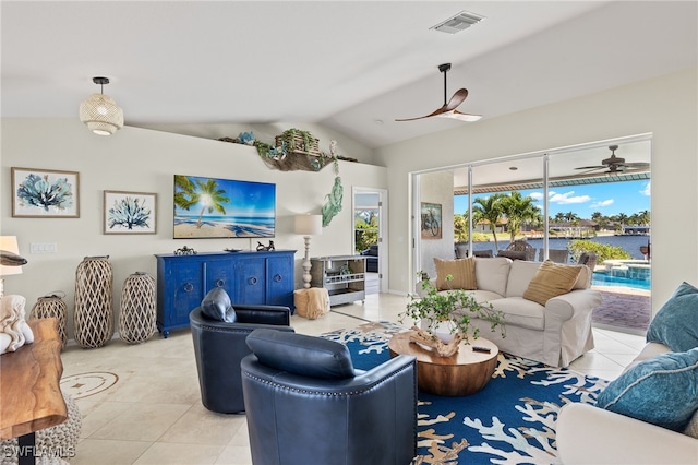 living room featuring ceiling fan, light tile patterned flooring, and vaulted ceiling