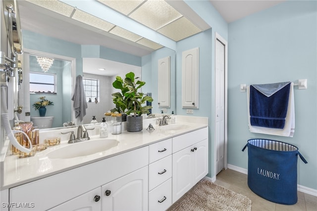 bathroom with tile patterned flooring, vanity, and toilet