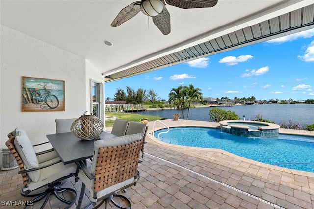 view of swimming pool with an in ground hot tub, a patio, and a water view