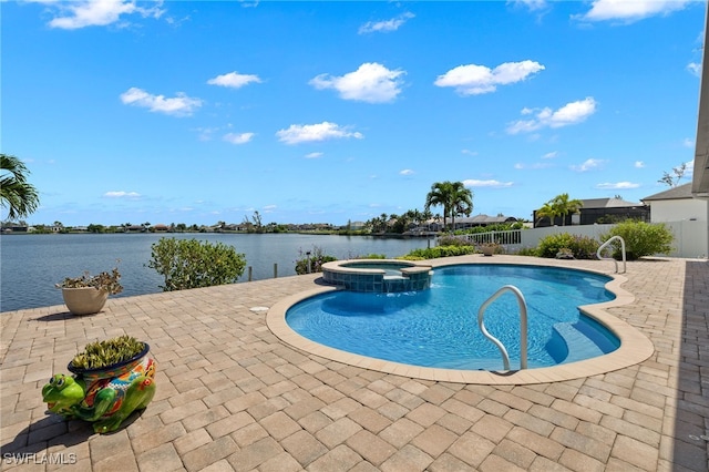 view of swimming pool featuring an in ground hot tub, a water view, and a patio