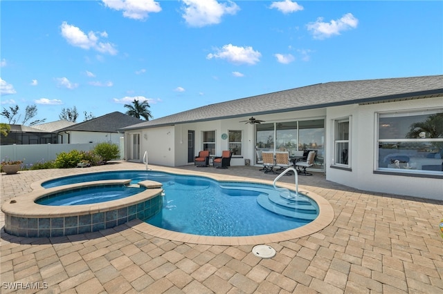 view of pool with ceiling fan, an in ground hot tub, and a patio