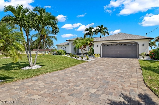 view of front of property with a front yard and a garage