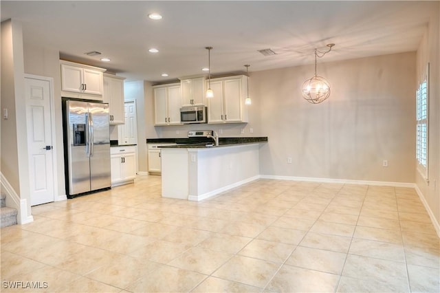 kitchen with pendant lighting, white cabinets, kitchen peninsula, and stainless steel appliances