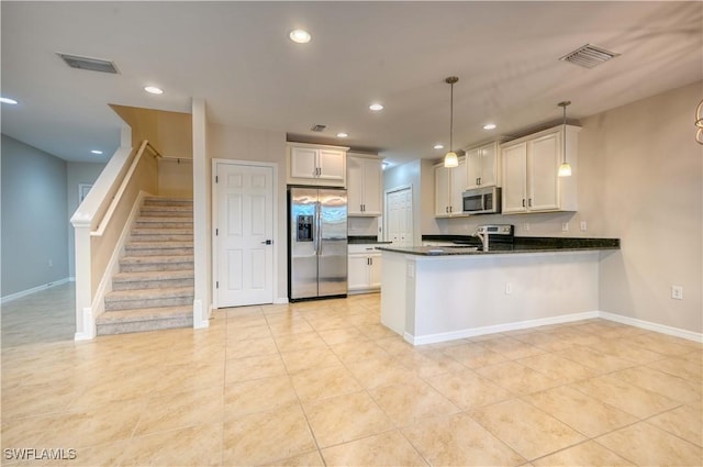 kitchen featuring white cabinetry, hanging light fixtures, stainless steel appliances, kitchen peninsula, and light tile patterned floors