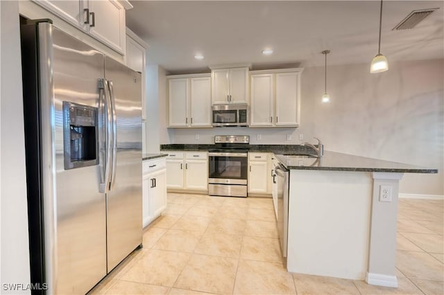 kitchen with decorative light fixtures, light tile patterned flooring, white cabinetry, and appliances with stainless steel finishes