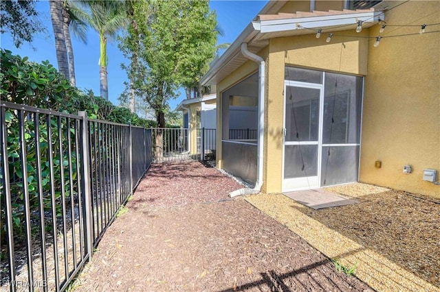 view of property exterior featuring a sunroom