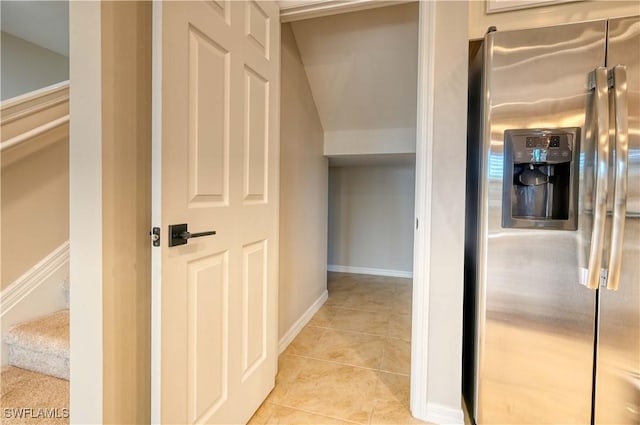 hall with light tile patterned floors