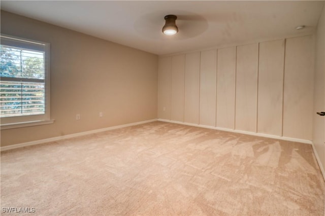 unfurnished room featuring light colored carpet