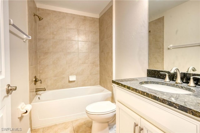 full bathroom featuring toilet, tile patterned flooring, vanity, and tiled shower / bath