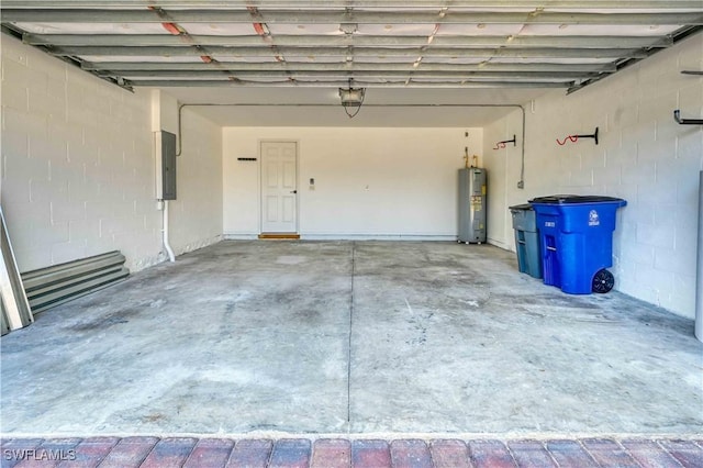 garage featuring electric panel and electric water heater