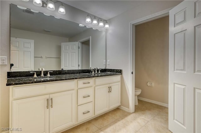 bathroom with tile patterned floors, vanity, and toilet