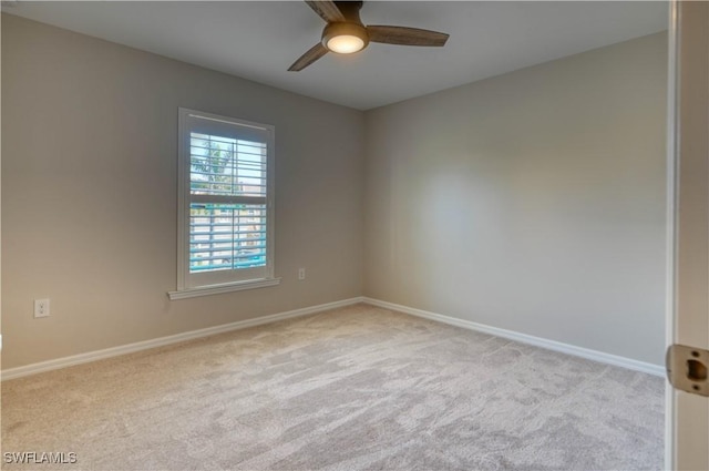 carpeted spare room with ceiling fan