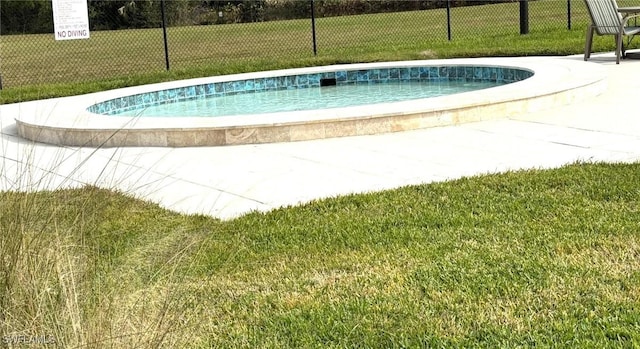 view of pool featuring a yard