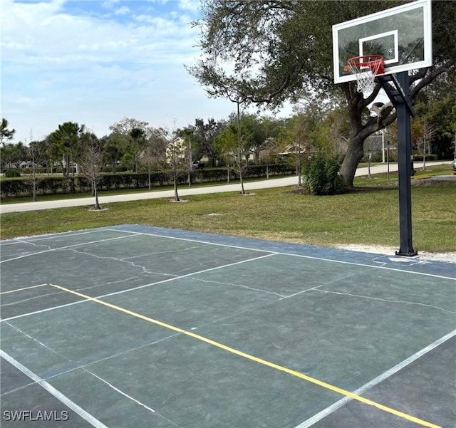 view of sport court with a yard