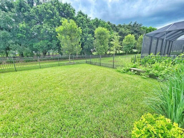 view of yard featuring glass enclosure