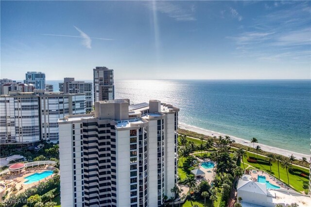 birds eye view of property with a water view and a view of the beach