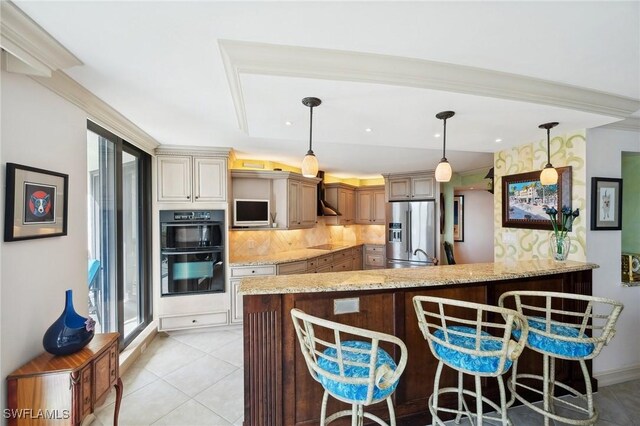 kitchen with kitchen peninsula, decorative backsplash, wall chimney exhaust hood, black appliances, and hanging light fixtures
