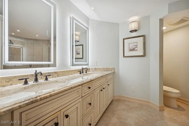 bathroom featuring tile patterned floors, vanity, and toilet