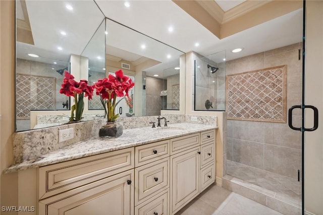 bathroom featuring vanity, tile patterned floors, an enclosed shower, and ornamental molding
