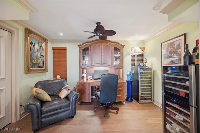 home office featuring ceiling fan, ornamental molding, wine cooler, and light hardwood / wood-style flooring