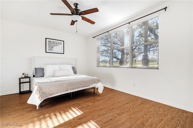 bedroom with hardwood / wood-style flooring and ceiling fan