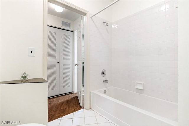 bathroom featuring tile patterned floors and tiled shower / bath combo