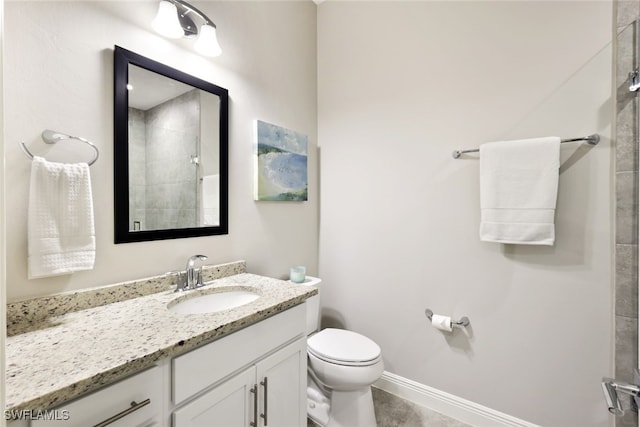 bathroom featuring vanity, toilet, and a shower with door