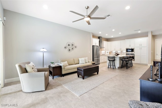 living room featuring ceiling fan and light tile patterned flooring