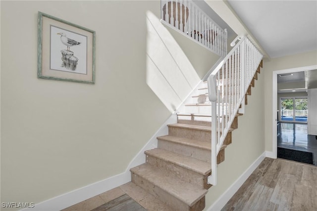 stairway featuring hardwood / wood-style floors