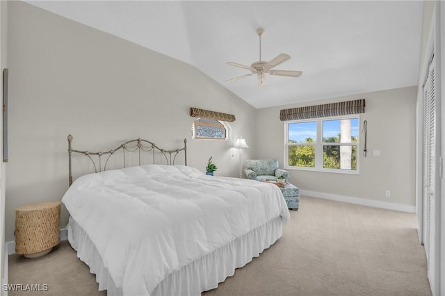 carpeted bedroom featuring ceiling fan, a closet, and vaulted ceiling