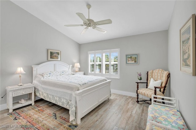 bedroom with ceiling fan, light hardwood / wood-style floors, and lofted ceiling